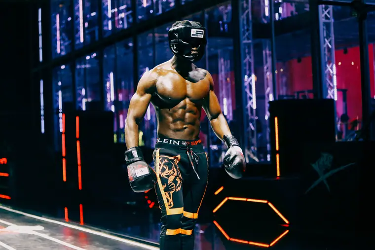 Model styled as a boxer in a neon-lit set
