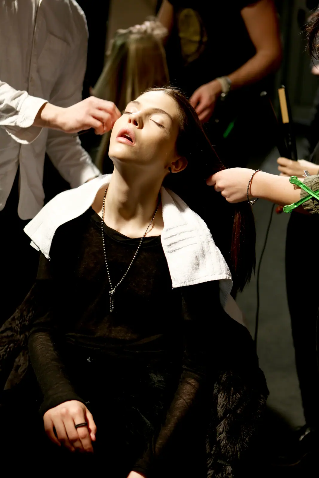 Model in black and white having her hair done backstage