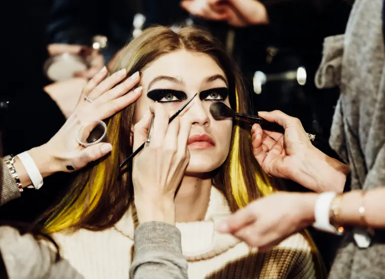 Gigi Hadid having her eye make-up applied