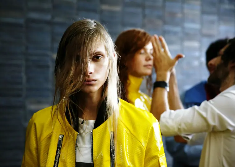 Model in a yellow coat in hair and make-up