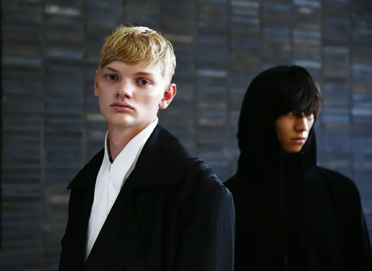 Two models in black, close up