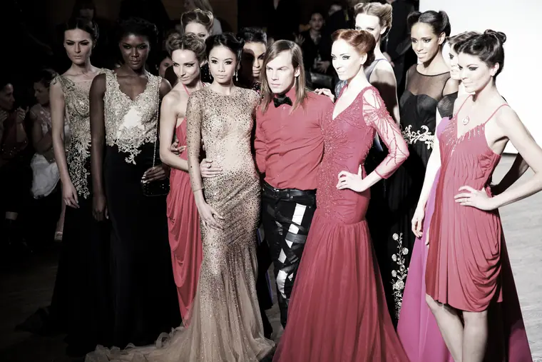 Models in pink gowns backstage