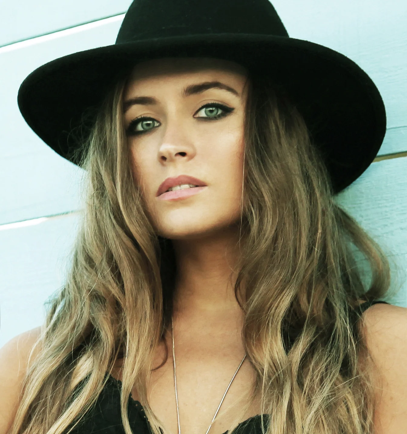 Close-up portrait of Elisha Naomi Daniel in a black hat