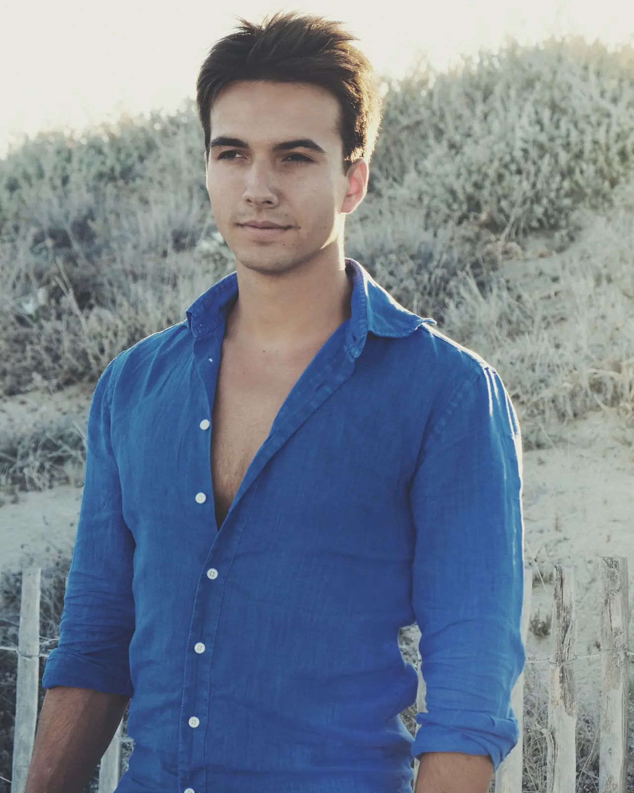 Man in a blue shirt among the dunes