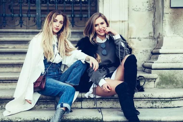 Two women seated on stone steps