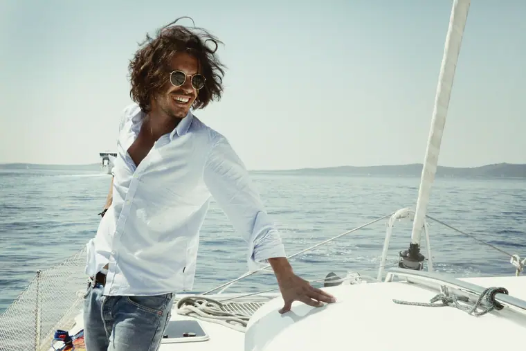 Man in a white shirt on a sailing boat